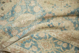Distressed Sivas carpet detail: faded denim blue, ivory lattice and even worn pile.