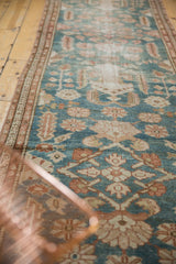 Distressed pile of a vintage Malayer runner, displaying allover large scale motifs in dusty blue and beige.