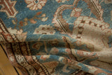 Folded view of distressed Malayer runner, highlighting dusty blue, ivory, and terracotta motifs.