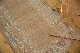 Distressed Malayer runner featuring staggered botehs, pale terra cotta, sand, and blue border.
