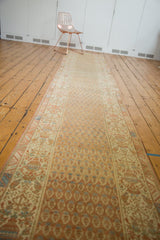 Distressed vintage Malayer runner's intricate border and staggered boteh patterns in sand and terra cotta.