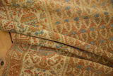 Soft pile texture of a distressed Malayer runner with muted beige, terra cotta, and blue boteh motifs.