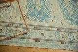 Geometric star patterns on antique style Soumac carpet border in ivory, slate blue, chocolate brown.