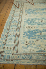 Soumac rug's geometric border and field design in ivory, slate blue, chocolate brown.