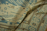 Detailed view of ivory, slate blue, and brown geometric motifs on a Soumac rug.