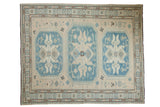 New Soumac carpet, ivory field, slate blue geometric medallions, bronze accents.