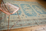 Hand woven Soumac carpet detail: geometric medallions, checkered florals in ivory and slate blue.