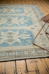 Fine weave geometric border of a Soumac carpet in ivory, slate blue, and brown.