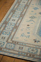Slate blue geometric border and playful stylized motifs on an ivory Soumac rug.