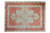 Vintage distressed Oushak rug with powder blue field, faded cherry red vinery, central medallion.