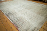 Distressed foundation texture, faded ivory, rose, and navy floral border.