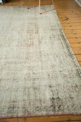 Distressed pile texture with visible foundation and faded ivory and rose tones.