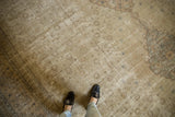 Distressed vintage Sivas rug detail featuring floral lattice field, partial medallion, muted ivory beige.