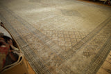 Distressed beige Sivas carpet corner displaying ornate border and faded floral lattice field.
