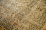 Distressed vintage Sivas carpet showing worn texture and faded beige floral motifs.