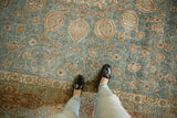 Distressed vintage Tabriz carpet with sapphire blue field, Safavid vinery, and visible wear.