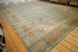 Distressed vintage Tabriz carpet detail: Safavid vinery, cartouche border, faded blue, red, beige.