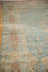 Distressed vintage Tabriz rug with cartouche border and muted blue, wine, ivory vinery.
