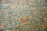 Distressed Tabriz carpet: Safavid vase motif, scrolling vinery, and muted blue field.