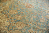 Curvilinear floral vinery in sapphire blue and dusty wine on a distressed vintage Tabriz carpet.