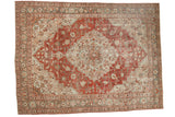 Distressed vintage Khoy carpet with a large brick red medallion on a pale slate blue floral ground.