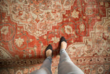 Low-pile texture and even wear of a vintage distressed Khoy carpet in red and slate blue.