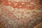 Corner detail of a distressed Khoy carpet showing the pale slate blue and silver floral borders.