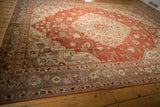Distressed Persian Khoy rug viewed from the side, highlighting its time-softened brick red and blue tones.