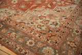Low-pile texture and floral borders on the corner of a distressed vintage Khoy carpet.