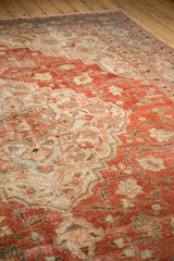 Even wear and low pile on a distressed vintage Khoy carpet in rich brick red.