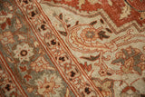 Hand-knotted pile detail showing faint foundation through brick red and silver-blue floral motifs.