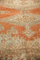 Distressed vintage Persian Veece carpet with pale rust and grey patterns, faint foundation showing through.