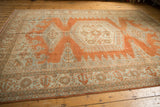 Distressed Veece carpet border with geometric patterns in pale rust, ivory, and slate grey.