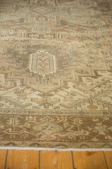 Distressed vintage Heriz carpet showing geometric serrated leaves and worn pile texture.