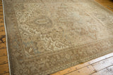 Vintage distressed Heriz carpet corner with geometric pattern and muted beige tones.