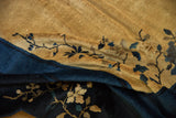Textured low pile and knot heads of a vintage Peking carpet in dusty gold and indigo.