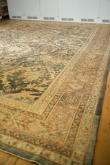 Time-softened terracotta and charcoal tones on a distressed Persian Mahal carpet seen from a low angle.