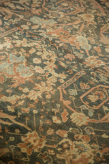 Worn, hand-knotted pile of a distressed Mahal rug with terracotta and blue floral details.