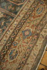 Low-pile texture of a distressed Mahal's paneled borders in rust, charcoal, and dusty blue tones.