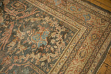 Charcoal field meets the ornate, time-softened borders of a vintage distressed Mahal carpet.