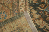 The hand-knotted weave and secured corner of a distressed vintage Persian Mahal rug.