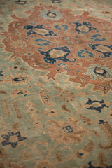 Distressed vintage Tabriz carpet pile showing even wear, seafoam green, and pale rust leaves.