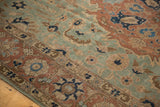 Vintage distressed Persian Tabriz carpet, seafoam green field, pale rust border, navy floral motifs, and soft, even wear.