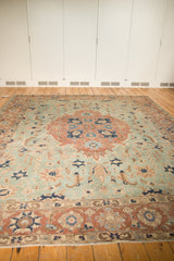 Distressed Tabriz carpet corner showcasing pale rust border, seafoam green field, and secured fringe.