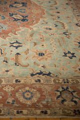 Textured pile of a distressed vintage Tabriz carpet in seafoam green, pale rust, and navy.
