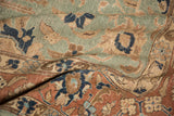 Distressed vintage Tabriz carpet detail: seafoam green, pale rust, navy florals, even wear to knot heads.