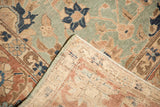Distressed seafoam green pile and hand-knotted foundation of the vintage Tabriz carpet.