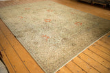 Distressed Tabriz carpet's faint foundation showing through faded floral vinery.