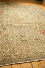 Distressed vintage Tabriz rug showcasing seafoam green field, floral vinery, and soft terra cotta.