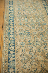 Detail of vintage distressed Hamadan runner: Herati motif, blue meandering vine border, and even wear.